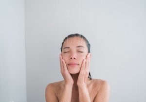 a woman using a body scrub